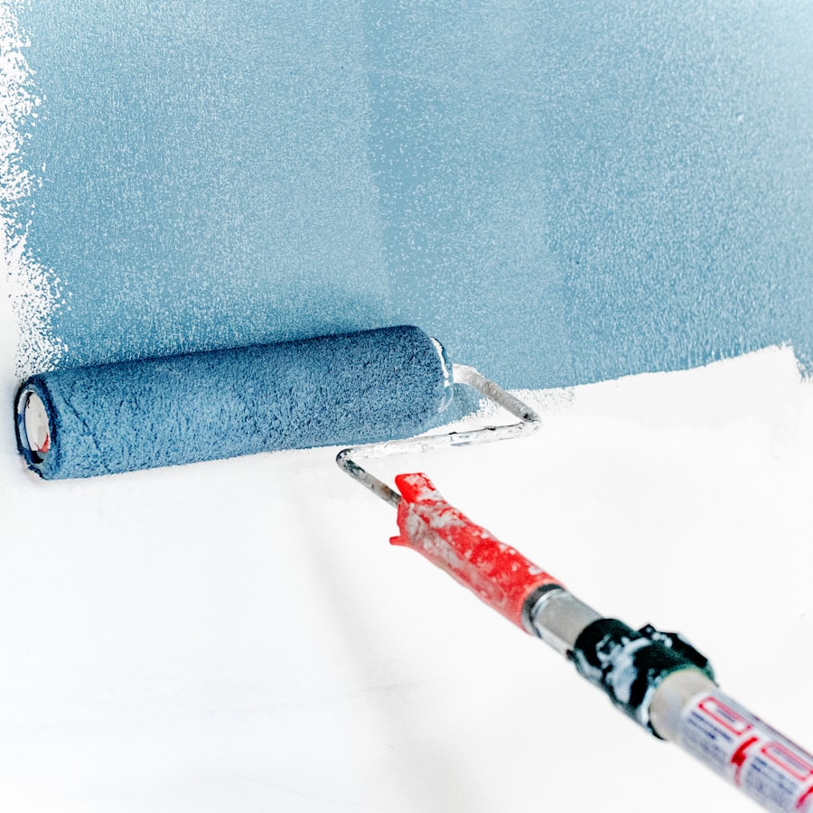 Paint roller against a freshly painted wall